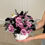 Thumbnail: Pumpkin Vase With Black and Purple Flowers