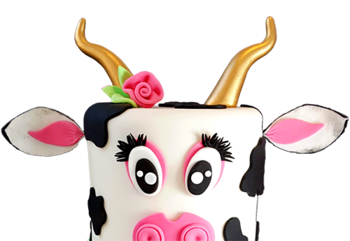 Cow cake named Flo with gold horns, a gold bell, a rose in her hair, and long eyelashes