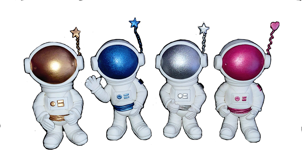 four astronaut cake toppers in white space suits with accent colours of gold, blue, silver and pink