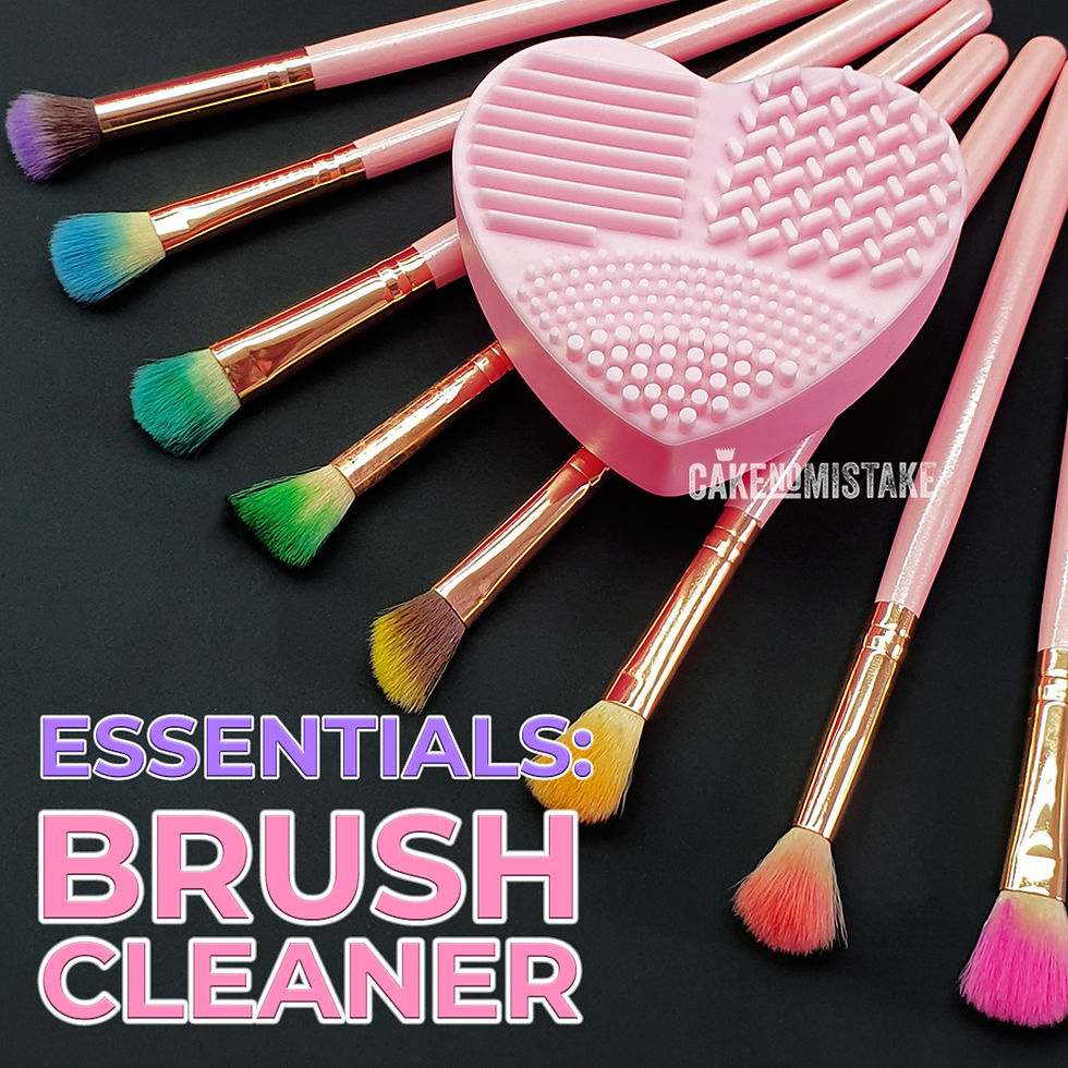 Pink heart-shaped silicone brush cleaner with fluffy brushes that have bristles covered in colourful edible dusts.