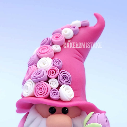 Pink gnome with rose hat and holding large lilac rose