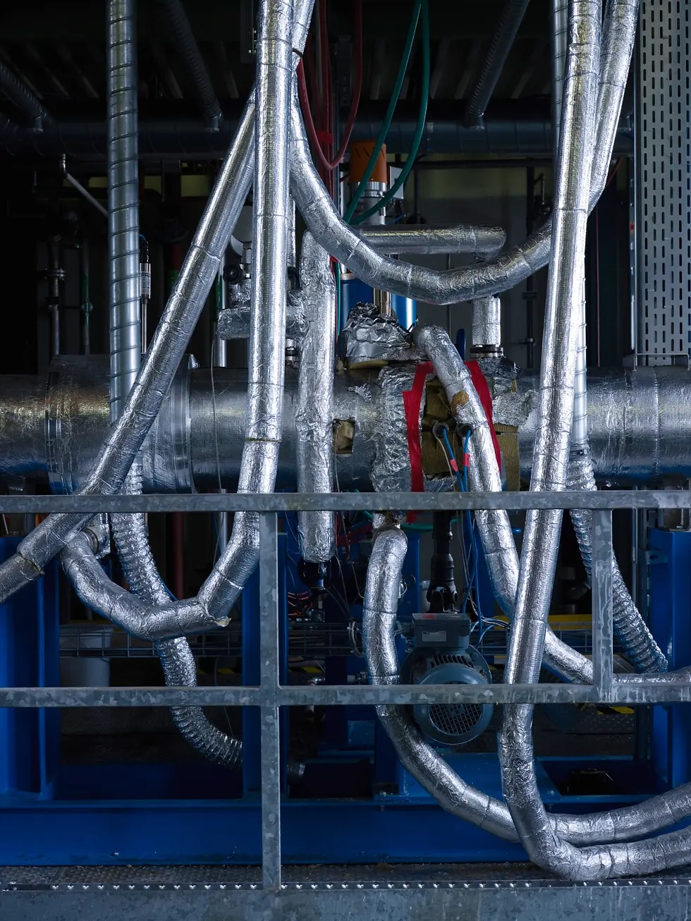 Operator conducting pilot-scale testing on Sulzer equipment in a process development facility.