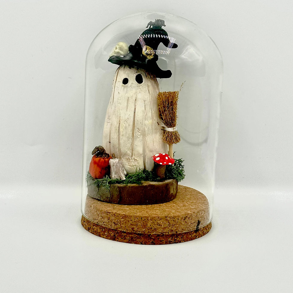 Vintage ghost hand made from clay in a glass cloche