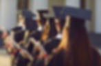 group-graduateuniversity-graduates-line-up-hold-degree-award-in-graduation-ceremony-rear-v