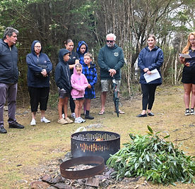Group of people at a smoking ceremony