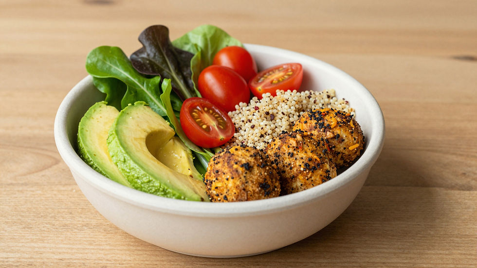Salad bowl with avocado, tomatoes, and quinoa veggie patties