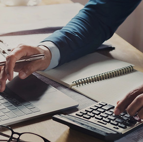 businessman-workig-using-calculator-with