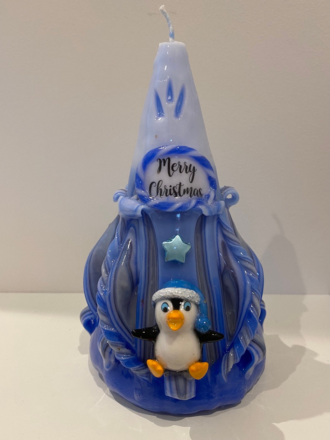 Blue hand carved Christmas candle with penquin