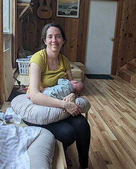 Client feeling supported and nurtured while holding her baby, receiving hourly postpartum care from Labyrinth Postpartum Care