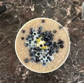 Warm, nourishing congee, a healing postpartum meal offered in Labyrinth Postpartum Care’s Ayurvedic postpartum package, supporting recovery and nourishment for new mothers