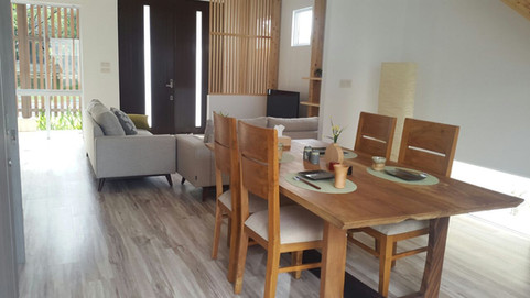 Living/dining room with wooden dining table and chair in a residential home in Delta Mas, Cikarang. 
