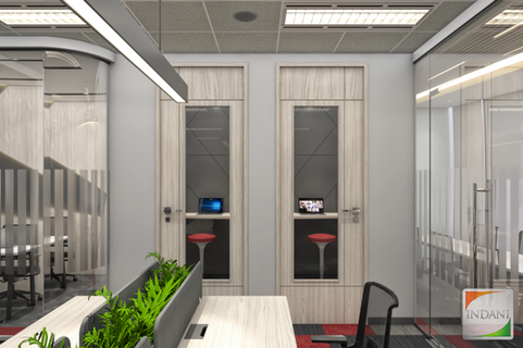 Part of office with two doors of two booth with a chair each and a computer, this is meant for online meeting.
