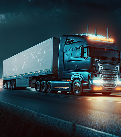 Blue semi‑truck on highway at night, Baltimore MD freight transportation.