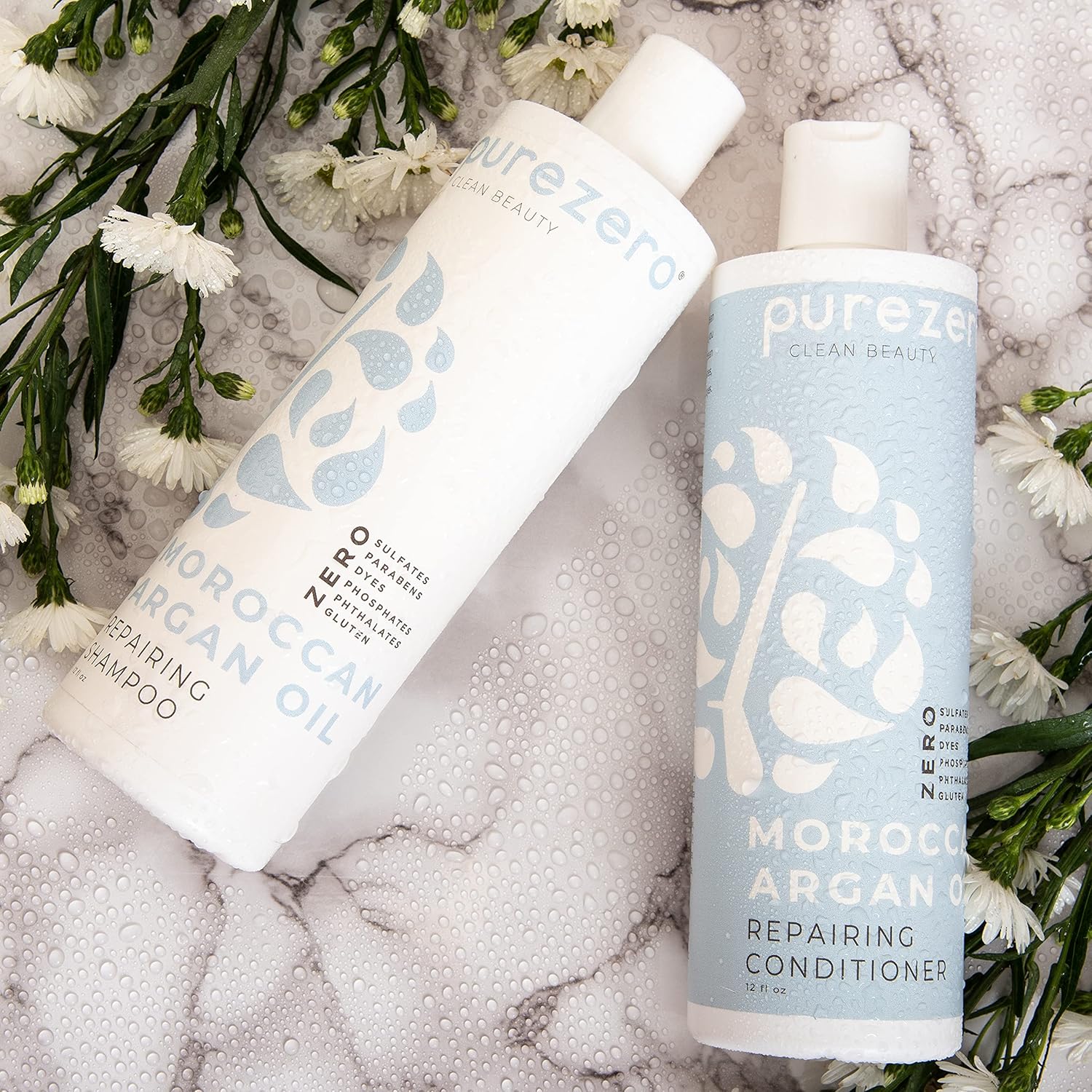 Two Purezero Moroccan Argan Oil bottles on a wet marble surface with white flowers. Text includes ‘Repairing Shampoo’ and ‘Conditioner.’
