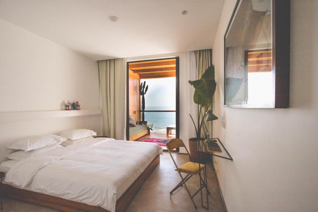 a bedroom with balcony in amouage hotel in taghazout witch ocean view