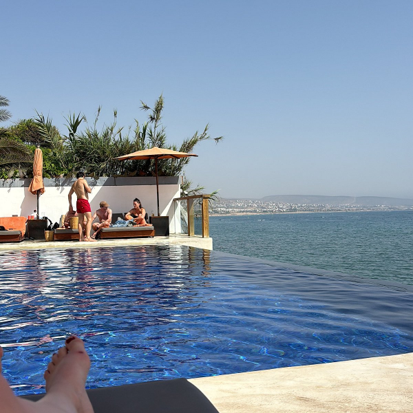 people sunbathing by swimming pool in amouage hotel in taghazout morocco