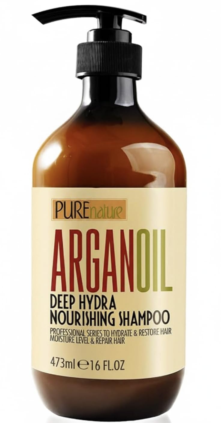 Brown bottle with black pump labeled ‘PUREnature ARGAN OIL Deep Hydra Nourishing Shampoo,’ 473ml. Cream label with green and red text.