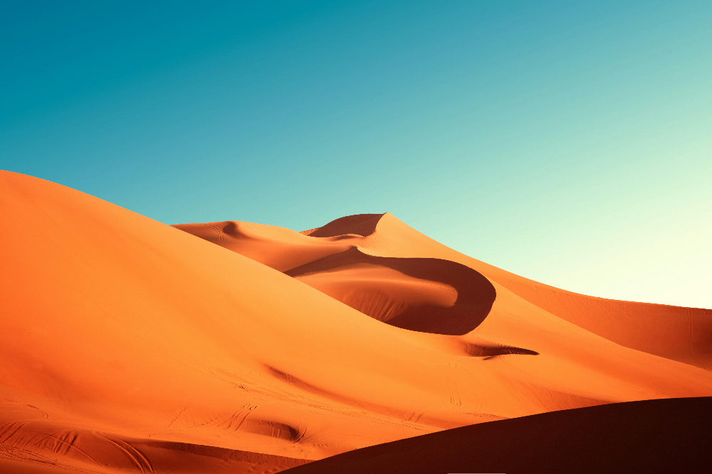 merzouga dunes under the sun and blue sky in morocco