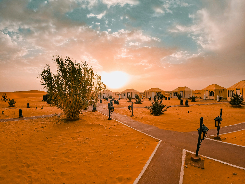 sand dunes next to tents in a sahara camp in erg chebbi morocco