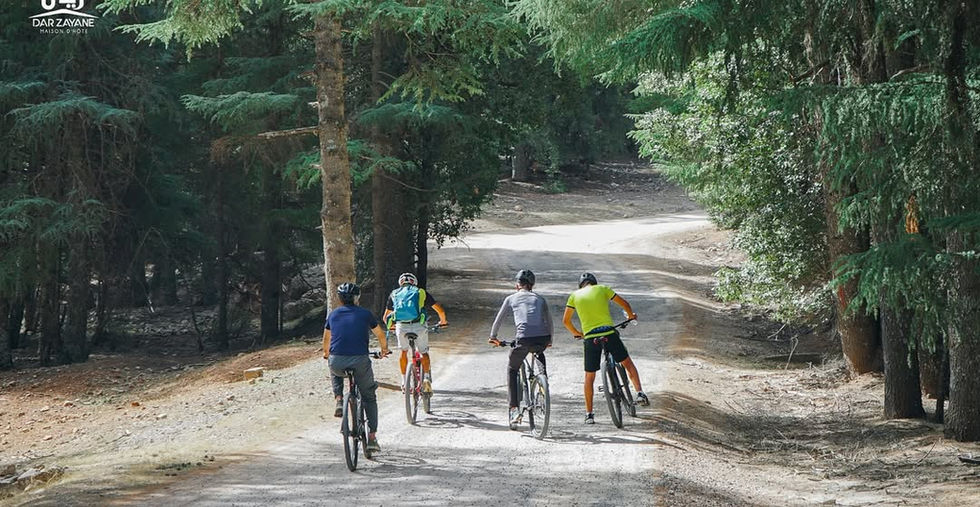 Dar Zayane visitors riding bikes in the middle Atlas, Morocco.