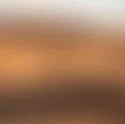 a caravan of toursist riding camels on sahara dunes in morocco