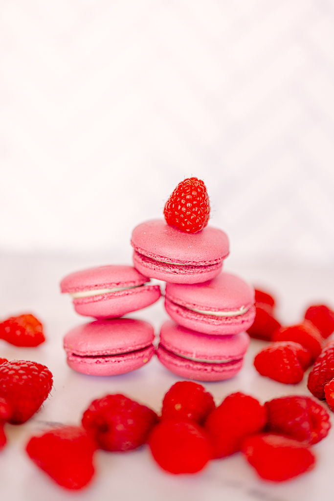 Pink macarons stacked with a raspberry on top, surrounded by scattered raspberries on a white surface. Bright and inviting mood.
Capturing the Sweet Side of Tampa: A Food Photographer’s Journey. Nina Bashaw Photography