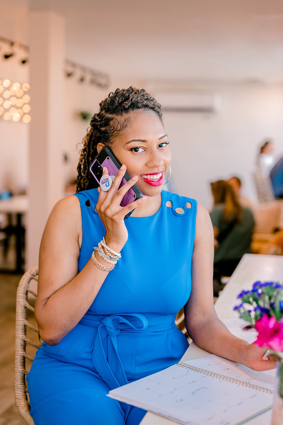 Woman in blue dress smiling, talking on phone in bright room. Holding a planner with flowers nearby. Relaxed, cheerful mood.
10 Outfit Ideas for Women to Elevate Their Headshots. Advice from Tampa Headshot Photographer Nina Bashaw