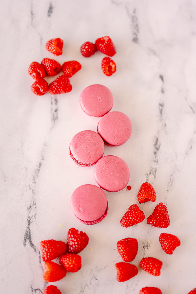 Pink macarons and scattered raspberries on a white marble surface. Bright, contrasting colors create an inviting, cheerful mood.
Capturing the Sweet Side of Tampa: A Food Photographer’s Journey with Nina Bashaw Photography