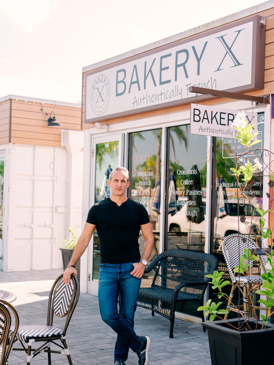 Business portrait of Xavier Vital with clean composition and modern café branding aesthetic.