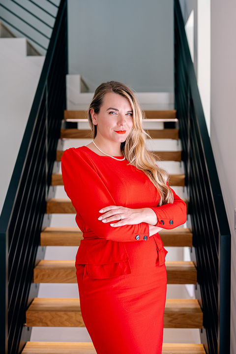 Professional branding portrait of luxury realtor Irina Osuji with elegant business styling.