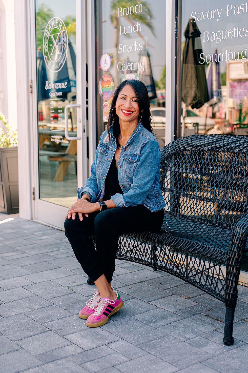 Seated portrait of Bridgette Vital smiling in outdoor setting at The Krates photographed by Wesley Chapel headshot photographer Nina Bashaw