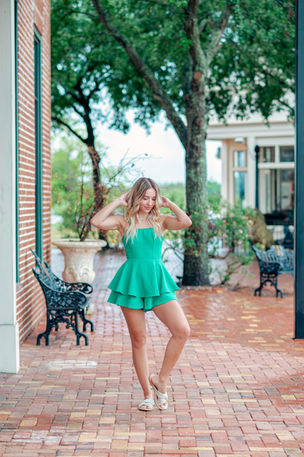 Senior girl smiling at golden hour during her portrait session with Wesley Chapel senior portrait photographer.