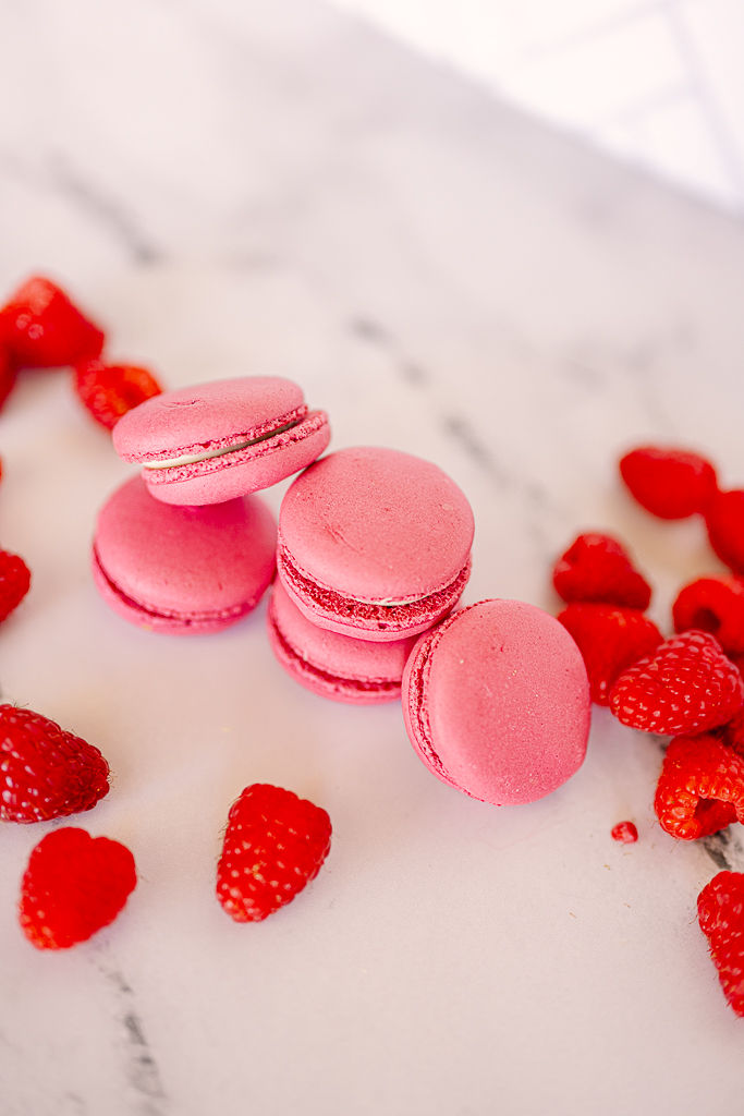 Pink macarons stacked on a white marble surface, surrounded by scattered fresh raspberries. Bright and vibrant dessert scene.
Capturing the Sweet Side of Tampa: A Food Photographer’s Journey with Nina Bashaw Photography
