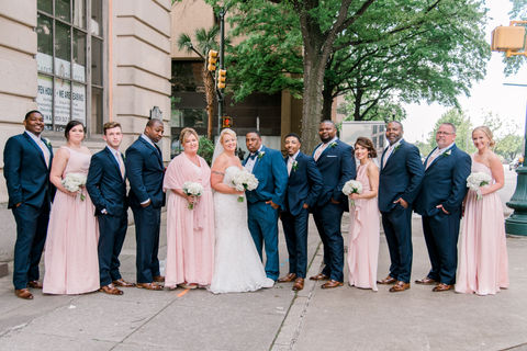 Bridal party laughing and smiling together during outdoor wedding portraits in a downtown Florida setting