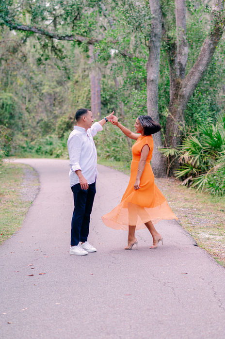 Couple holding hands during an engagement session at Lettuce Lake Park photographed by a Tampa engagement photographer and elopement photographer