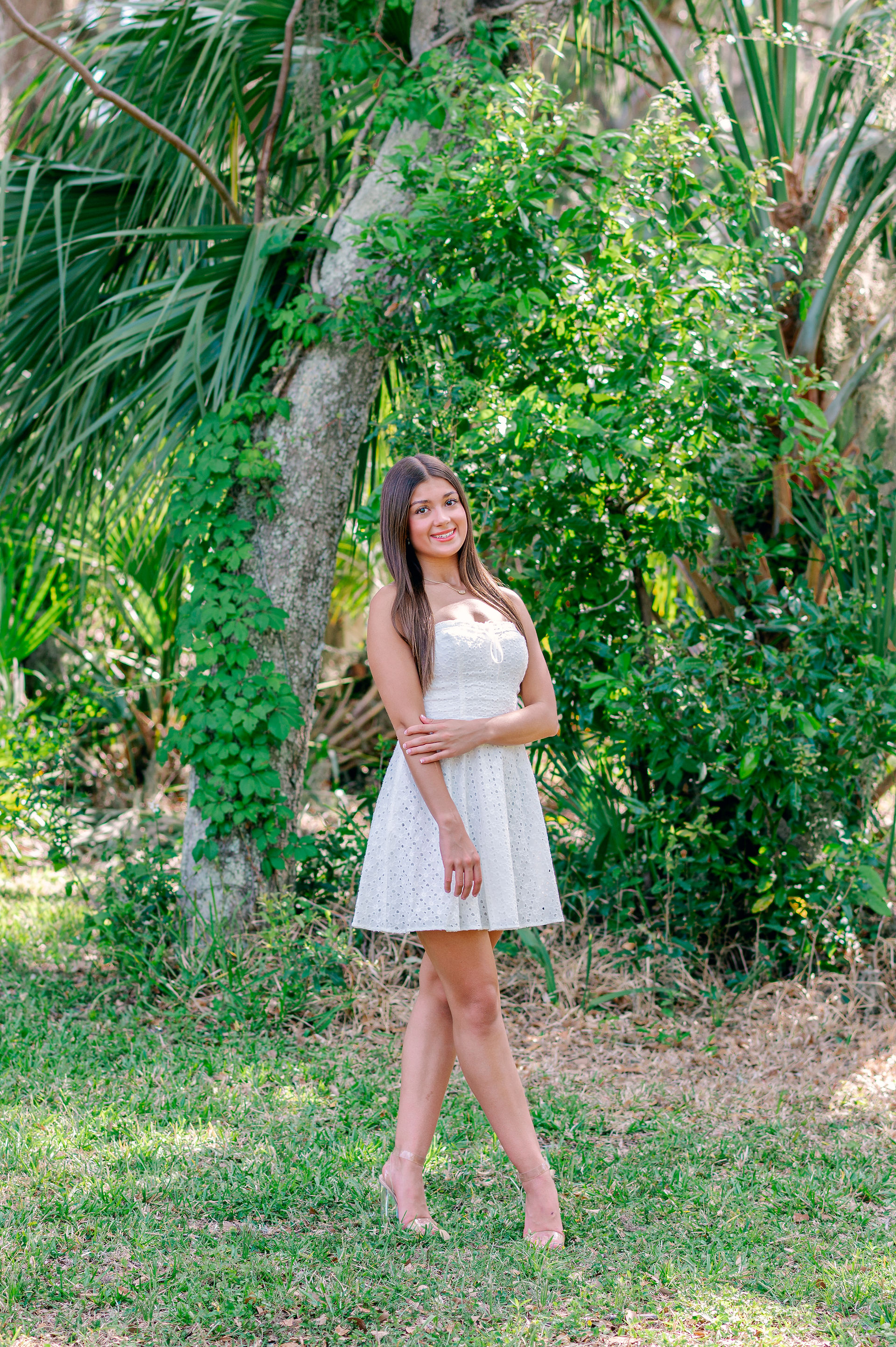 Senior girl smiling in white sundress with Spanish moss background photographed in Philippe Park by 