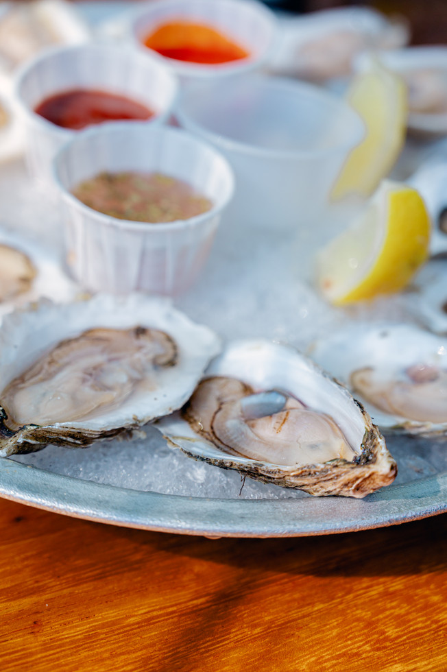 Fresh oysters served outdoors at Abel’s Lobster Pound in Bar Harbor. Photographed by Nina BashawA scenic coastal drive to Bar Harbor Maine and an unforgettable dining experience at Abel’s Lobster Pound through the lens of traveling food and branding photographer Nina Bashaw