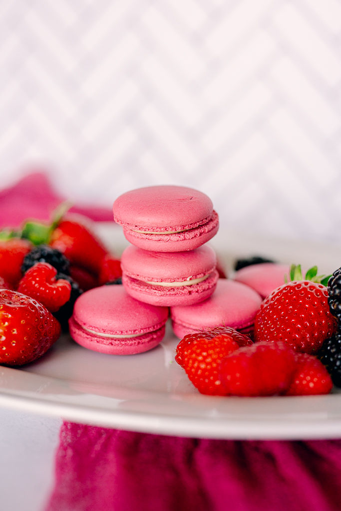 Pink macarons stacked on a plate surrounded by strawberries, raspberries, and blackberries. A pink cloth and chevron background.
Capturing the Sweet Side of Tampa: A Food Photographer’s Journey with Nina Bashaw Photography