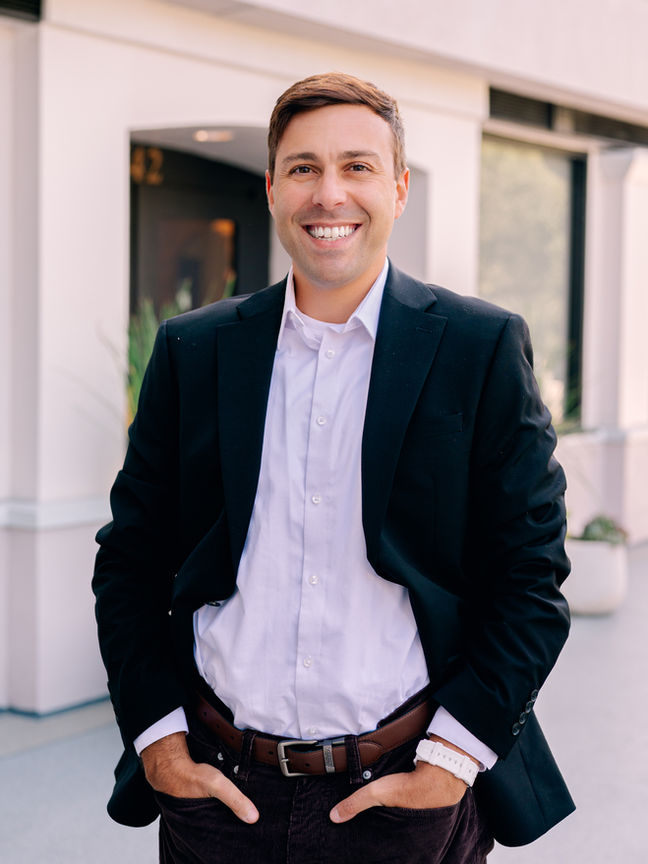 Outdoor headshot featuring natural tones and relaxed style. Shot by Tampa headshot photographer Nina Bashaw in Hyde Park Village to highlight personality and professionalism.