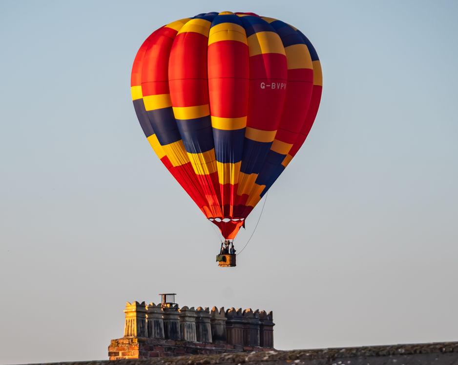 Hot air balloon over house