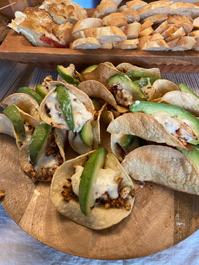 Spicy fish tacos with cream sauce and avocado on house-made shells