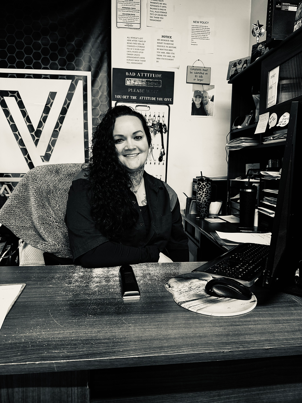 Front desk receptionist at V Auto Care in Tooele assisting customers at auto repair shop