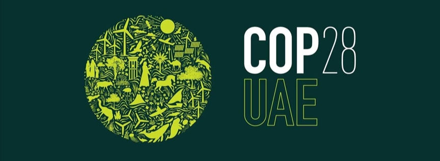COP28 UAE climate summit banner showing world leaders and negotiators gathered in Dubai in December 2023 to finalize the historic UAE Consensus on global net zero transition.
