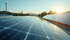 Solar panels reflecting sunlight at sunrise in a serene landscape with distant trees and hills, evoking a calm, eco-friendly mood.