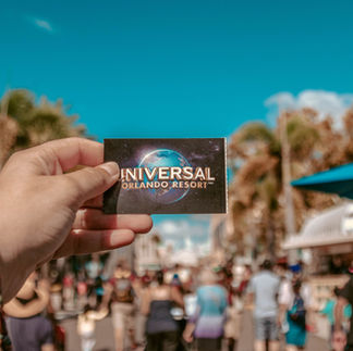 A person holding Universal Studios Singapore card in hand.