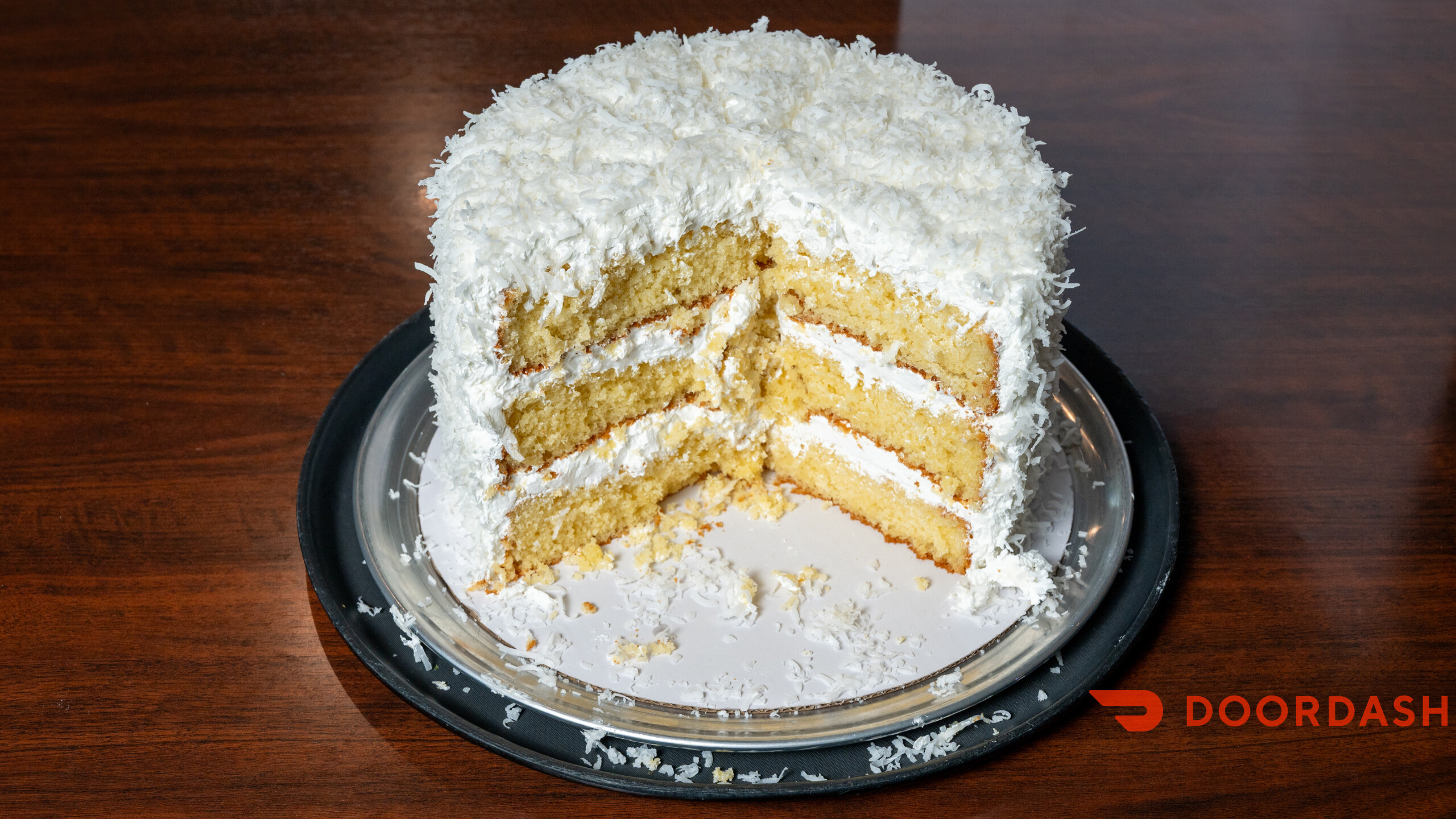 Slice of coconut cake from the Mayfair Seafood dessert menu