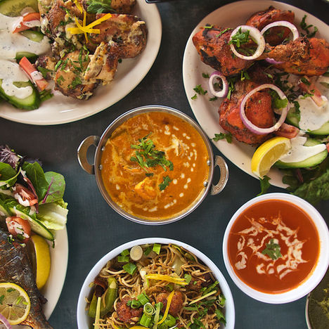 Delicious Indian food spread with chicken, fish, and curries