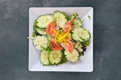 Cucumber and tomato salad with dressing