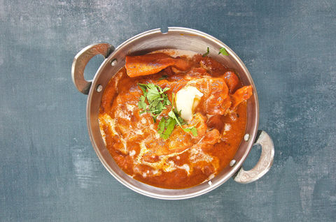 Creamy curry with cilantro in a metal pot