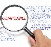 Magnifying glass looking at the word compliance